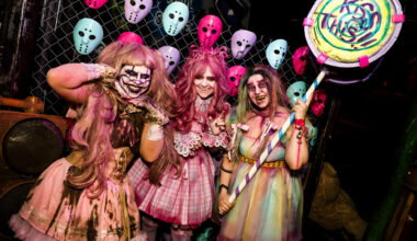 Colorful costumes in a spooky setting.